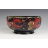 A Moorcroft pomegranate pattern footed bowl, mid 20th century, impressed marks and blue painted