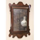 A William and Mary style walnut framed wall mirror, the rectangular mirrored plate within a
