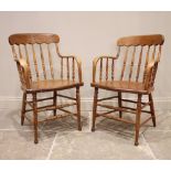 A near pair of Victorian ash, elm and beech spindle back elbow chairs, each formed with a concave