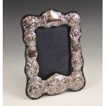 A silver mounted photograph frame, John Bull Ltd, London 1981, of rectangular scalloped form, the