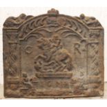 A cast iron fire back, indistinctly bearing the date '1674', of arched form and cast in relief with