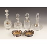 Four cut glass decanters, of assorted shapes and sizes, measuring between 24.5cm and 32.5cm, with