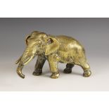 A Japanese brass elephant, Meiji period (1868-1912), realistically modelled standing, signed to