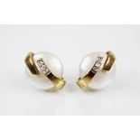 A pair of pearl and diamond 9ct gold earrings, each designed as a button pearl, approximately 10mm
