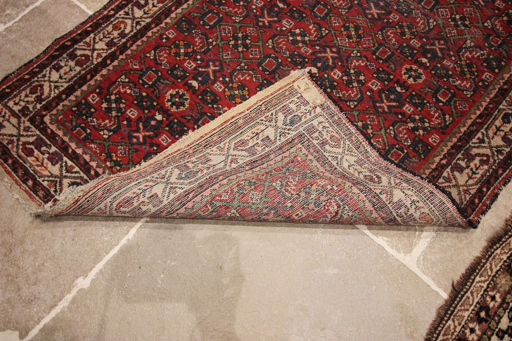 A Caucasian hand knotted wool carpet, in brown, blue, black and white colourways, the central - Image 3 of 3