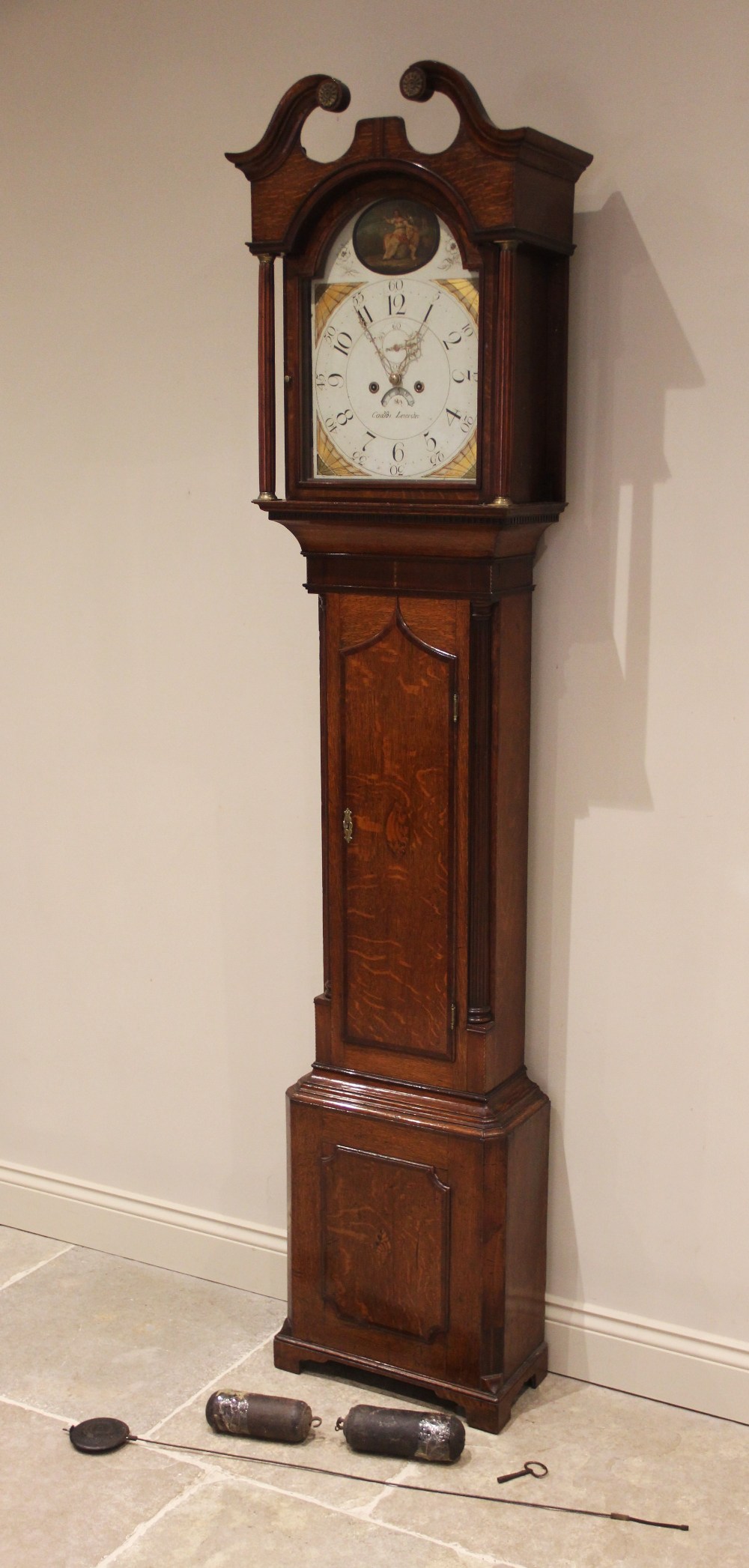 A George III oak cased eight-day longcase clock, indistinctly signed Leicester, the hood with a twin