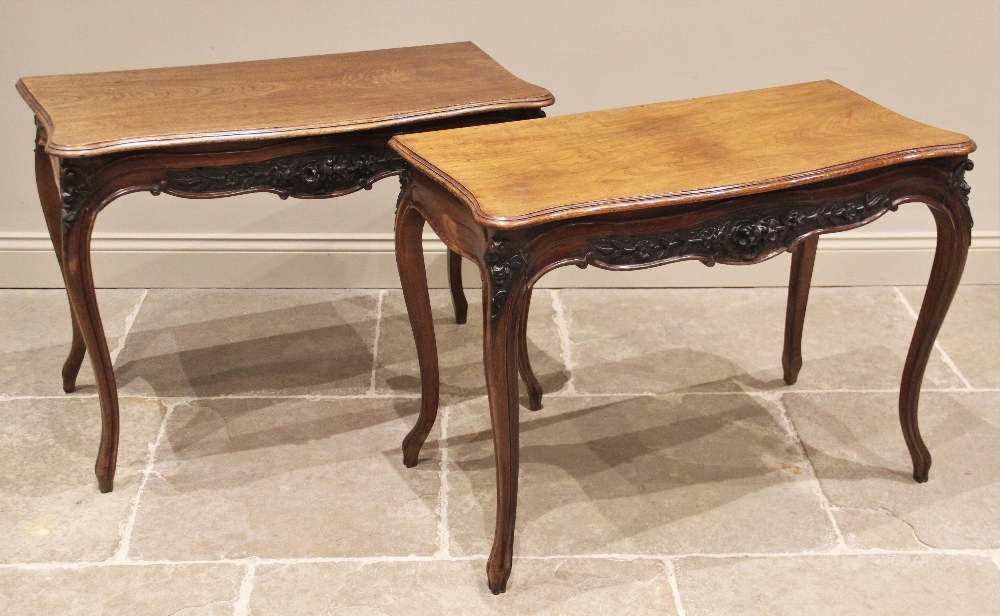 A pair of Louis XV style walnut console tables, early 20th century, each with a moulded serpentine