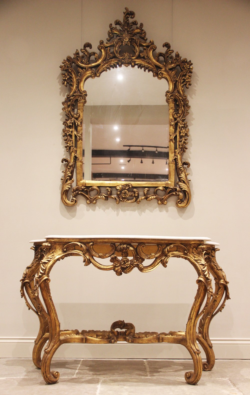 A Rococo revival giltwood and gesso marble top console table and mirror, mid 20th century, the
