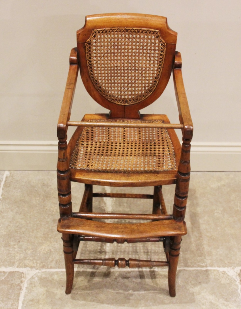 An Edwardian stained beech child's metamorphic high chair and walker with bergère shield shape - Image 5 of 5