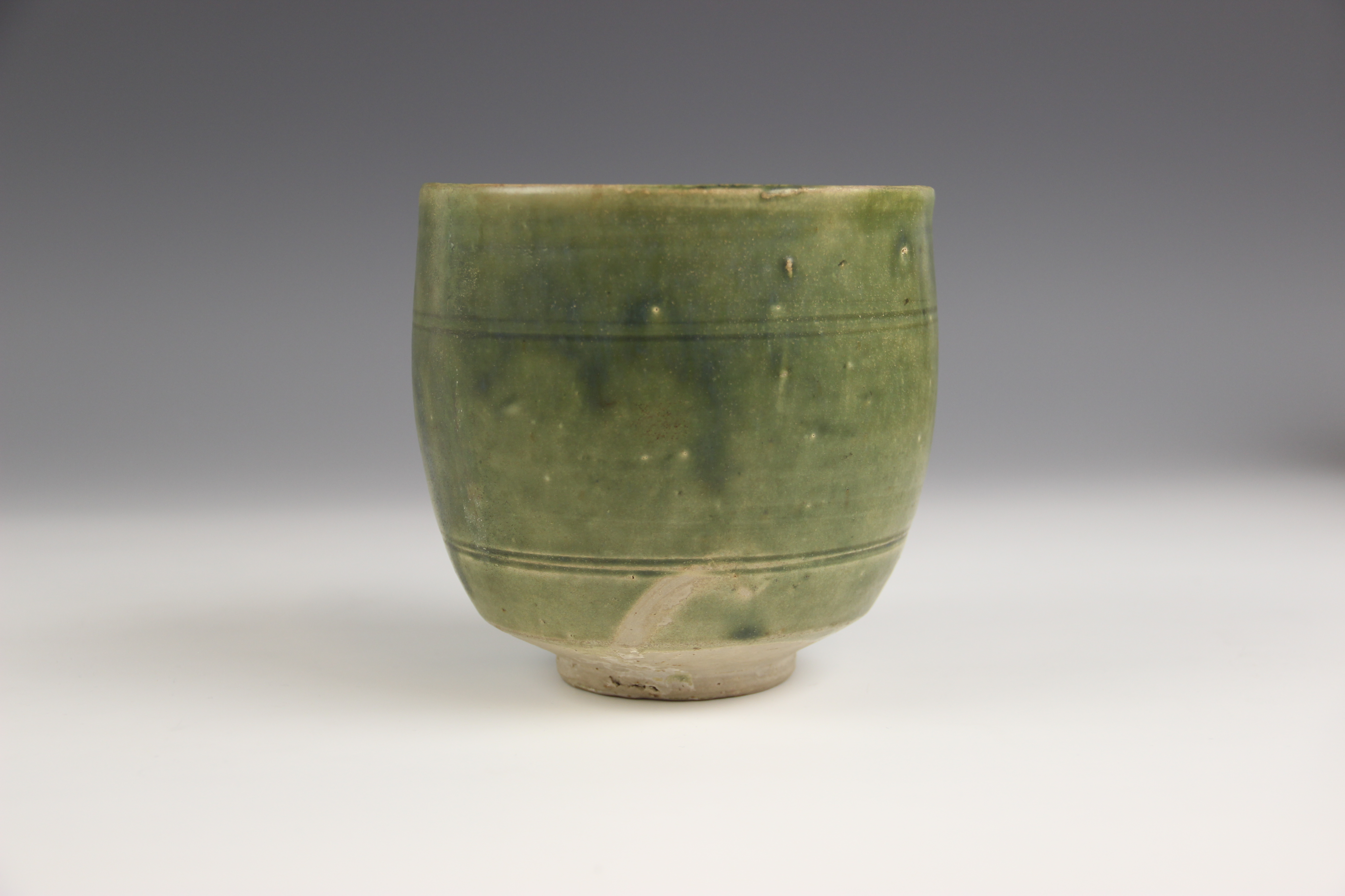 An Anamese pottery vessel, possibly 15th century, the cylindrical vase celadon glazed to the - Image 7 of 9