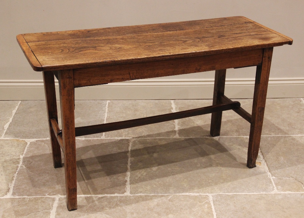 An elm plank top side table, probably French, early 19th century, the cleated top raised upon legs