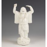A Chinese Blanc de chine porcelain figure of Buddha, 19th century, modelled standing with arms