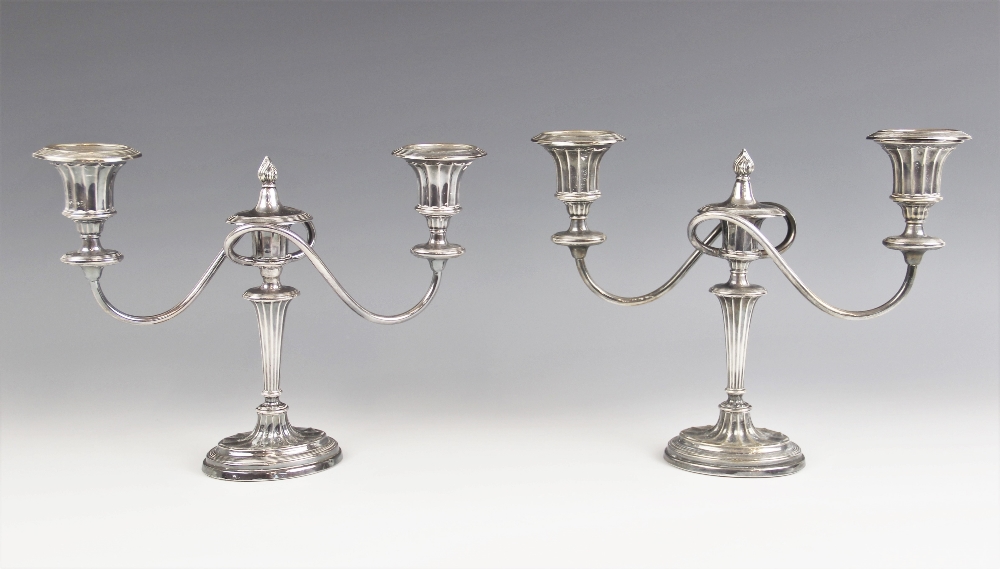 A pair of Edwardian silver candelabras, Ellis & Co, Birmingham 1906, the tapering fluted stems above