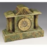 A Victorian green onyx mantel clock, the case of architectural form with a pair of freestanding