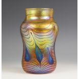 A John Ditchfield for Glasform studio glass vase of waisted form, the iridescent amber glass with