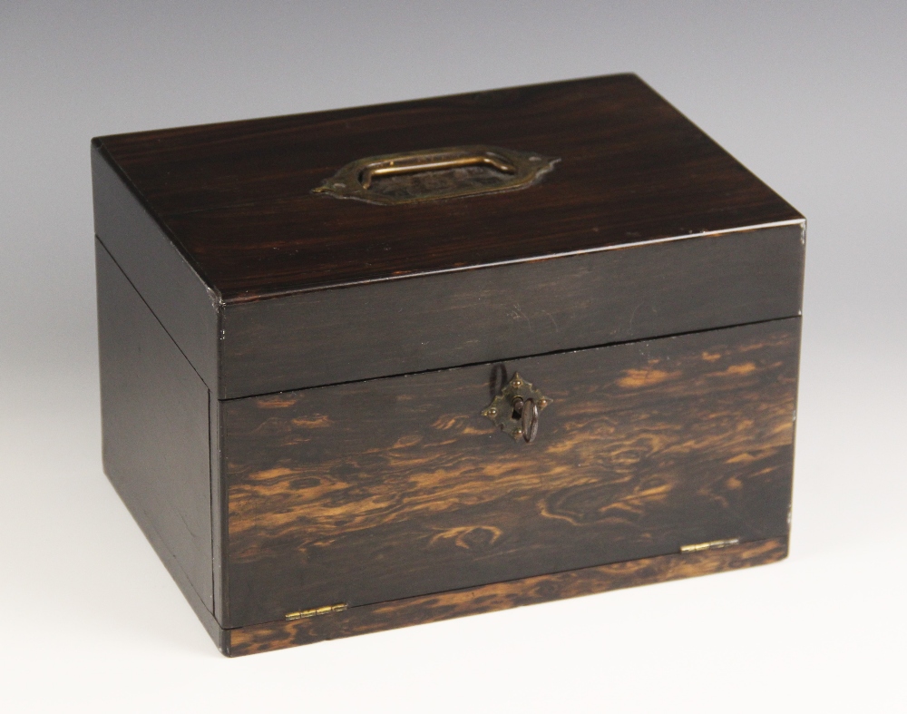 A mid 19th century rosewood jewellery box, the hinged cover inset with a brass swing handle over a