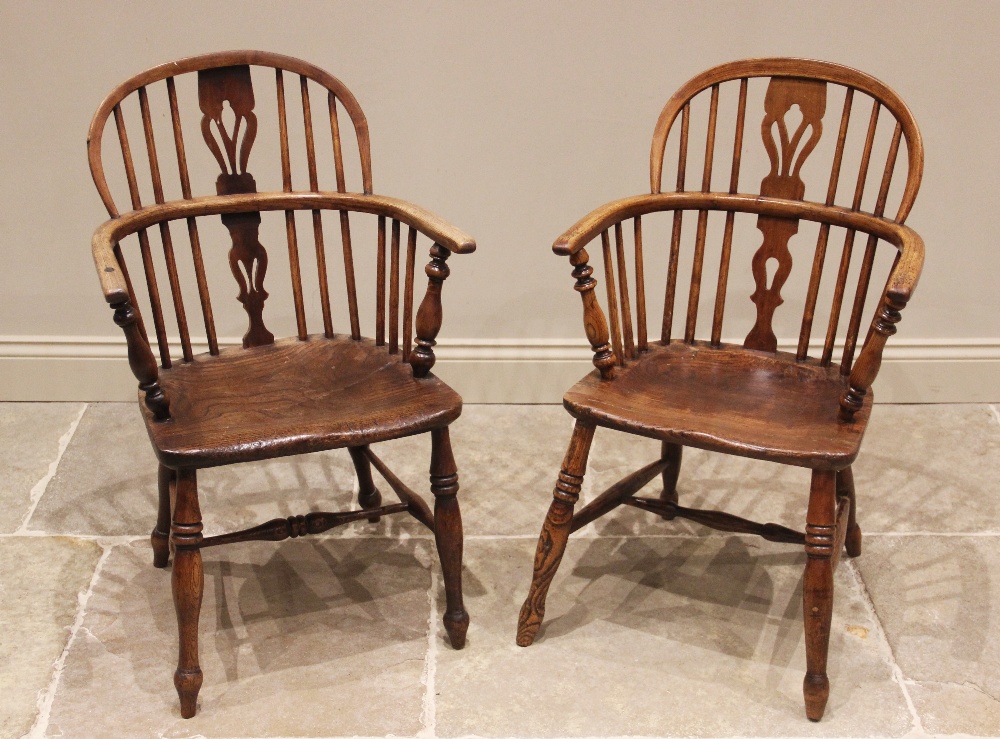 A near pair of ash and elm Windsor elbow chairs, early 19th century, each with a hoop back and