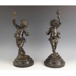 Two patinated bronze putti, 19th century, each modelled as the infant Bacchus, one standing on a