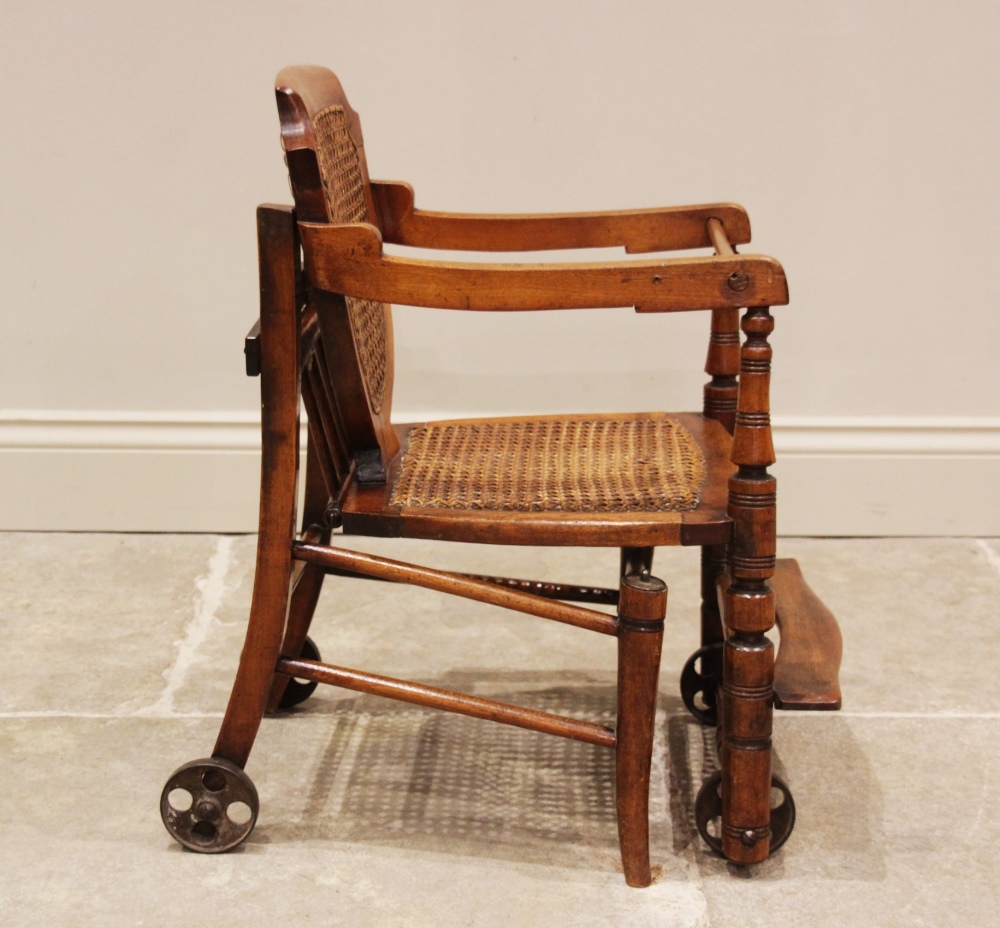 An Edwardian stained beech child's metamorphic high chair and walker with bergère shield shape - Image 3 of 5