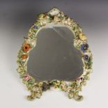 A Rococo style porcelain florally encrusted mirror, late 19th century, the trefoil scroll and
