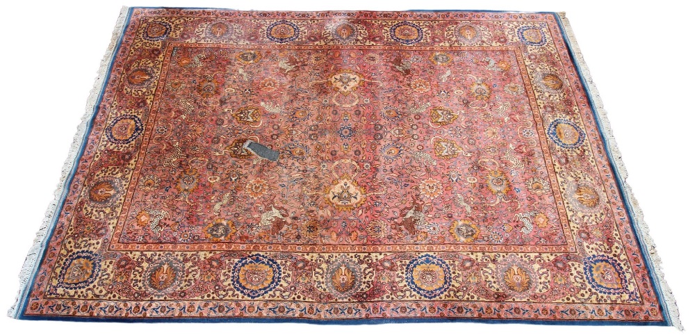 A large Persian pattern wool rug, in blue, pink and yellow colourways, the central field applied