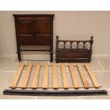 A pair of oak single beds, 18th century and later constructed, each with a panelled headboard and