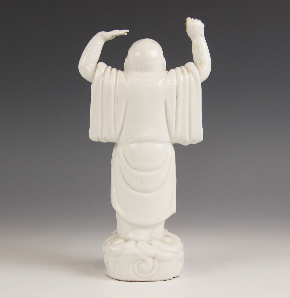 A Chinese Blanc de chine porcelain figure of Buddha, 19th century, modelled standing with arms - Image 2 of 2
