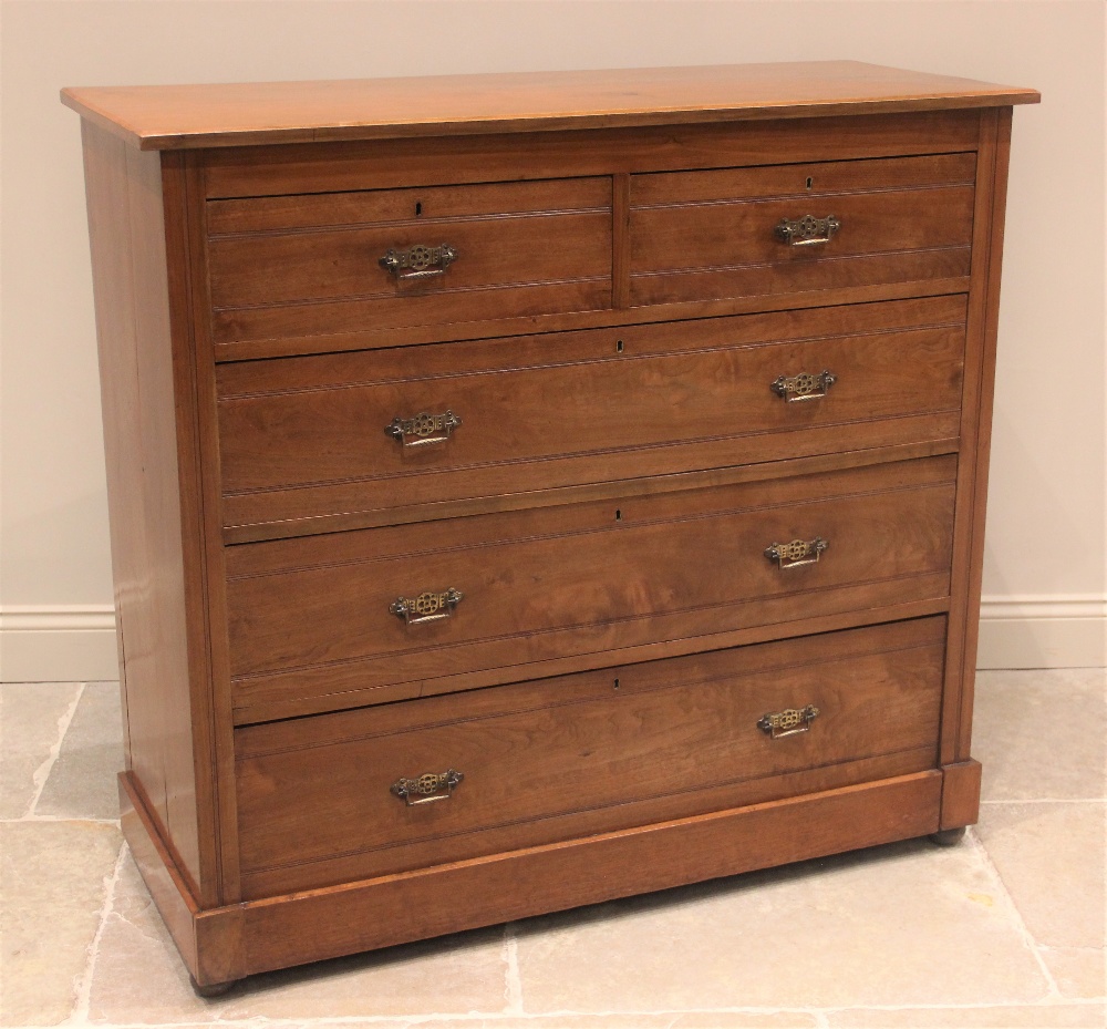 A late Victorian satin walnut chest of drawers, the rectangular moulded top above an arrangement