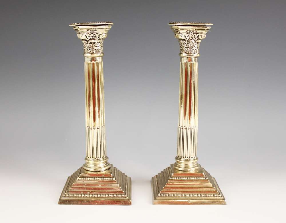 A pair of George V silver candlesticks, marks for 'WS', Birmingham 1921, the weighted stepped square