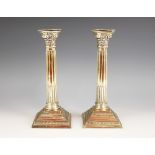 A pair of George V silver candlesticks, marks for 'WS', Birmingham 1921, the weighted stepped square