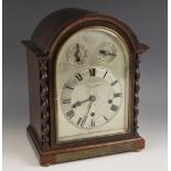 A 1920's oak cased bracket clock retailed by Pleasance & Harper, Bristol, the arched case with