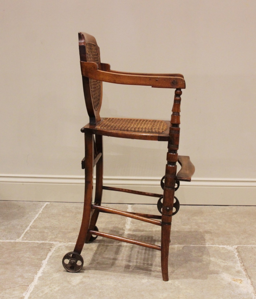 An Edwardian stained beech child's metamorphic high chair and walker with bergère shield shape - Image 4 of 5