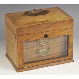 An Edwardian walnut jewellery casket, the gently domed hinged cover with an inset swing handle, over