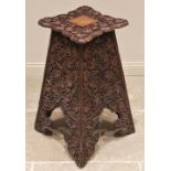 An Arts & Crafts carved walnut plant stand, in the manner of Arthur Simpson, Kendal, early 20th