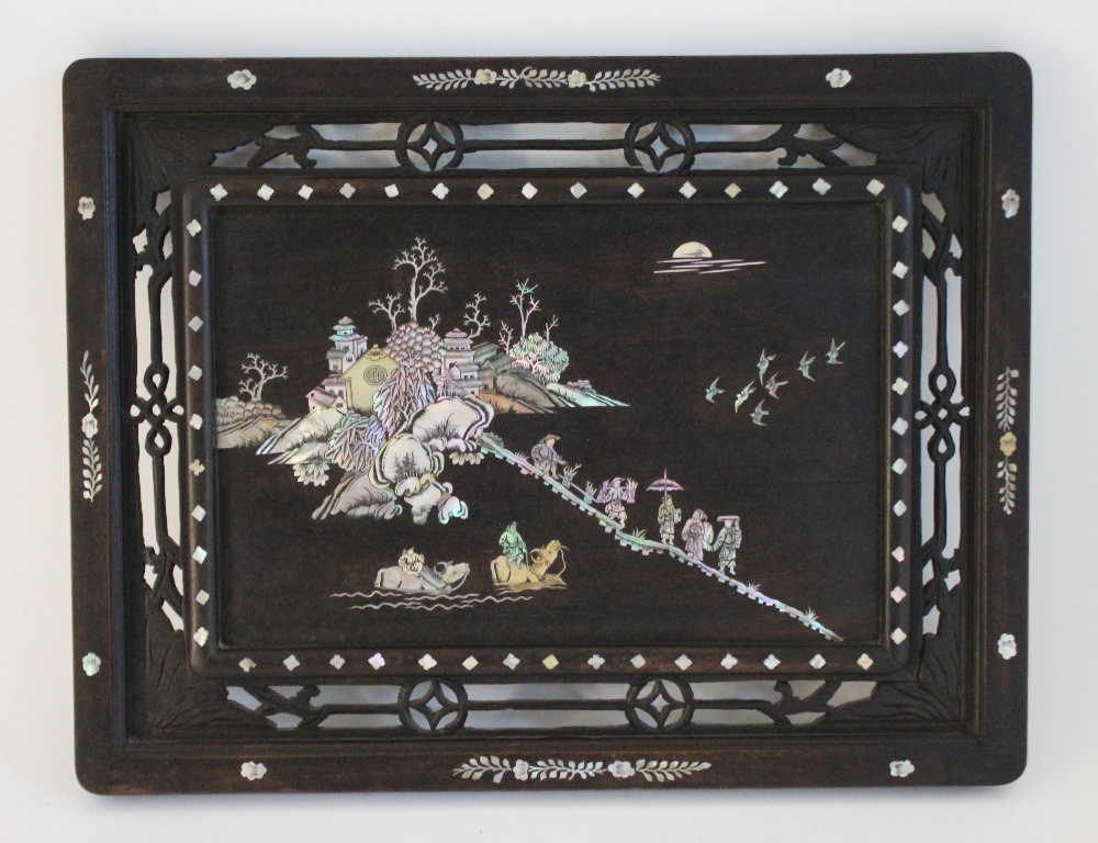 A Chinese mother of pearl inlaid panel, circa 1900, of rectangular form with foliate carved