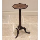 A George III oak candle stand, the octagonal top with a moulded rim, upon a tri-form tapering column