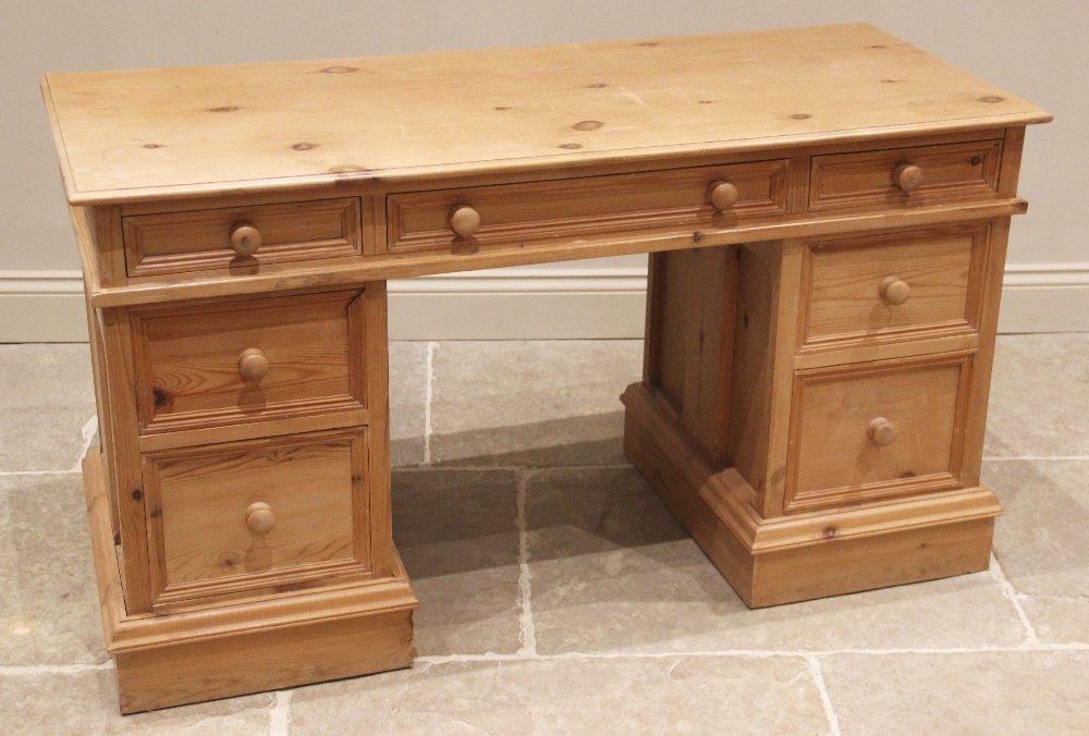 A Victorian style pine twin pedestal desk, late 20th century, the rectangular moulded top over three