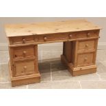 A Victorian style pine twin pedestal desk, late 20th century, the rectangular moulded top over three