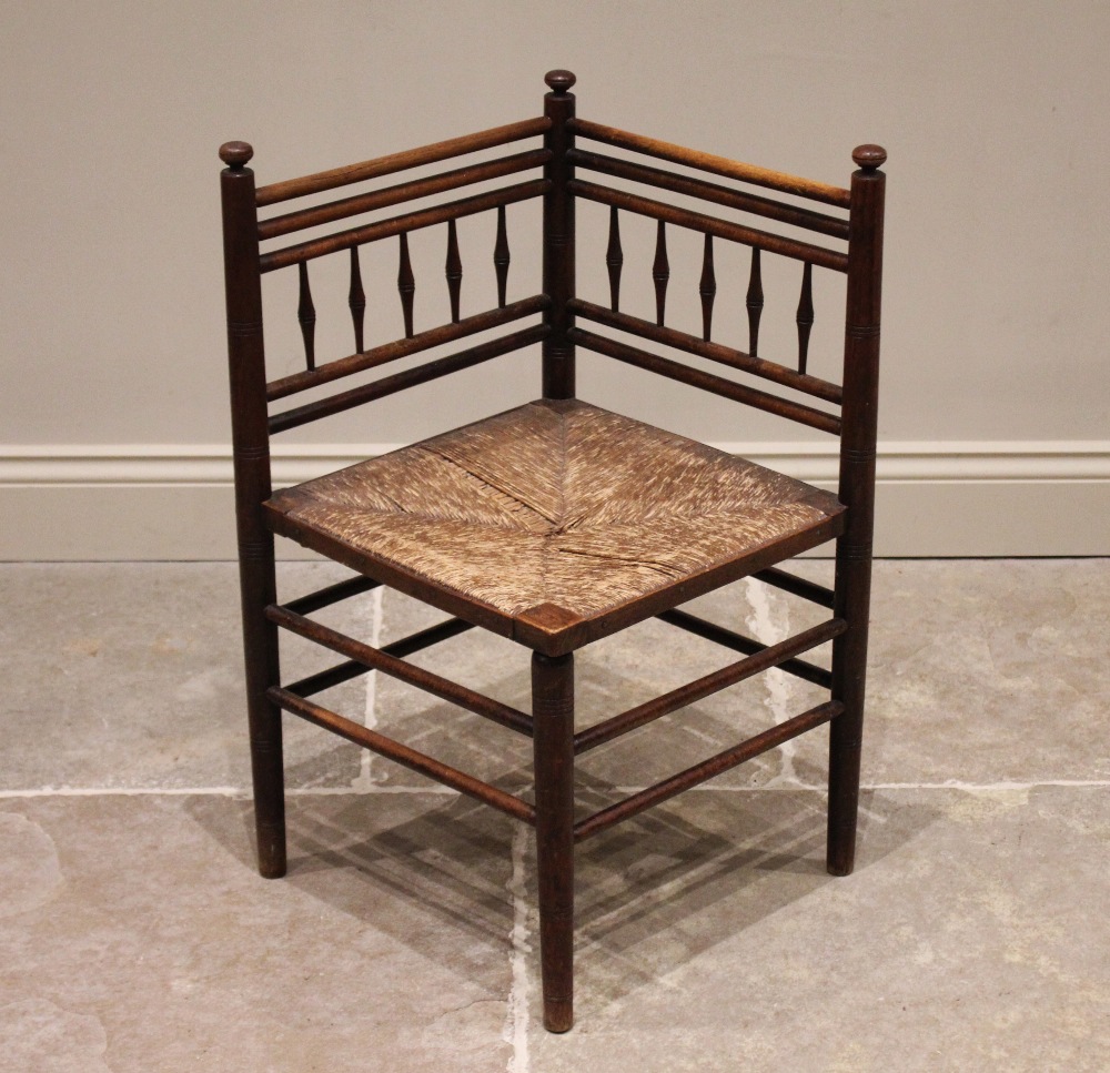 A 19th century corner chair, in the manner of Morris & Co, Sussex, the angular back rest with