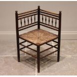 A 19th century corner chair, in the manner of Morris & Co, Sussex, the angular back rest with