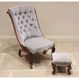 A Victorian carved walnut button back salon chair, upholstered in blue velour, the button back