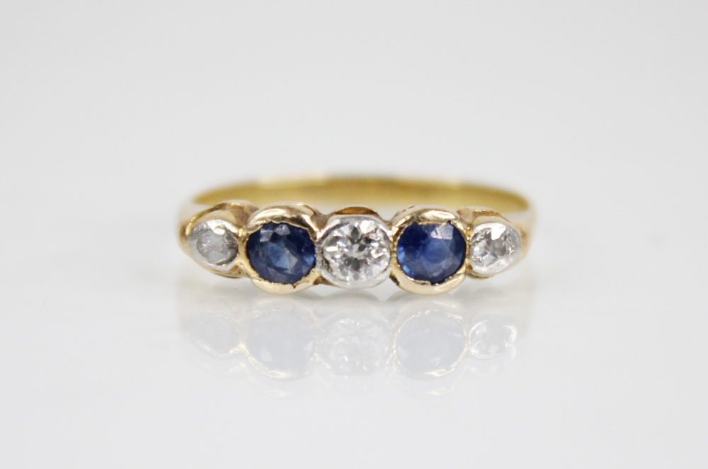 An early 20th century sapphire and diamond five stone ring, designed as a central round mixed cut