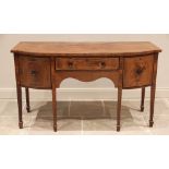 A George III mahogany bow front sideboard, outlined with ebony and boxwood stringing, the shaped and