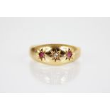 An Edwardian diamond, ruby and 18ct gold ring, comprising a central mixed cut diamond flanked by two