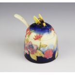 An Old Tupton ware honey pot, cover and spoon, tube lined and hand painted with a continuous