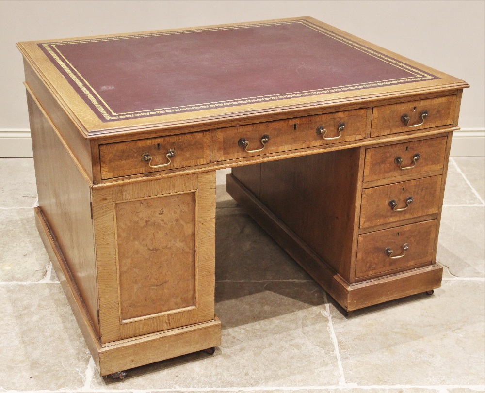 A late Victorian oak and pollard oak twin pedestal partners desk, the rectangular moulded top