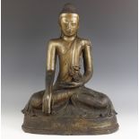 A large Burmese bronze buddha, seated in dhyanasana with hands placed in bhumisparsha mudra, sat