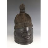 A West African Mende helmet mask, Sierra Leone mid 20th century, of typical form with incised