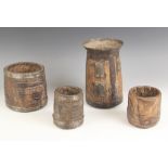 Four 18th century European sycamore and iron bound grain pots, smallest 10cm high and largest 21.5cm