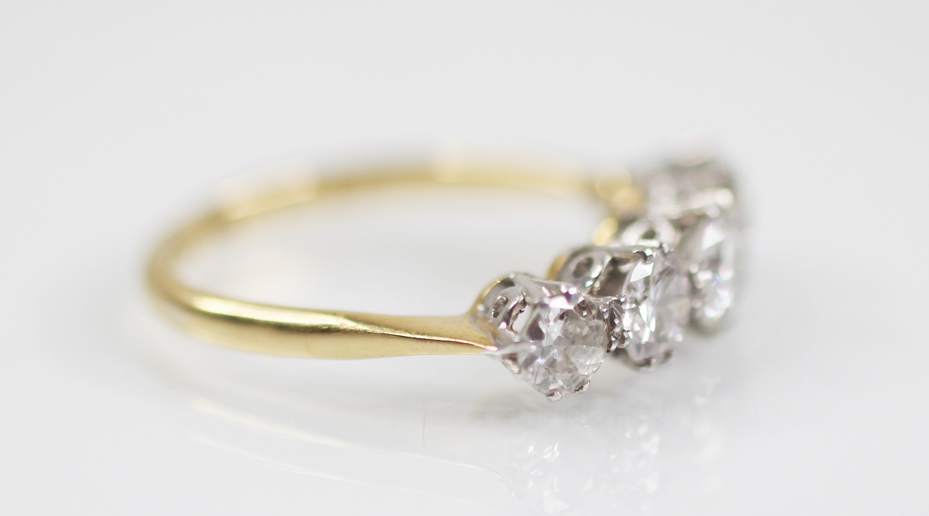 An early 20th century five stone diamond ring, the central round brilliant cut diamond - Image 2 of 6